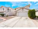 Inviting two-story home with a paved driveway and well-kept landscaping; featuring a spacious two-car garage at 1030 Wild Fern Ct, Las Vegas, NV 89183