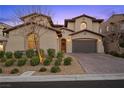 Charming two-story home featuring a two-car garage, desert landscaping and a brick driveway at 12125 Edgehurst Ct, Las Vegas, NV 89138