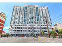 Modern high-rise apartment building with a sleek design, multiple windows, and street-level access in a bustling area at 150 Las Vegas Blvd # 1014, Las Vegas, NV 89101