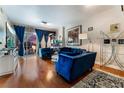 Modern living room with stylish blue velvet furniture, wood floors, and city view at 150 Las Vegas Blvd # 1014, Las Vegas, NV 89101
