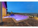 Outdoor oasis with modern pool, spa, and waterfall feature at 160 Stone Mesa Ct, Henderson, NV 89011