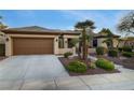 Single-story home with a neutral-toned exterior, complemented by a well-maintained front yard and spacious driveway at 1700 Wellington Springs Ave, Henderson, NV 89052
