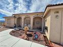 Home exterior with covered porch, decorative water fountain, and rock landscaping at 2300 S Washoe Ave, Pahrump, NV 89048