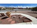 Front yard landscaping with rock cover, decorative rock features and water fountain at 2300 S Washoe Ave, Pahrump, NV 89048