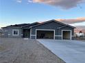 A single-story house with a three-car garage and a long driveway, offering ample parking and curb appeal at 2530 S Tecumseh Ave, Pahrump, NV 89048