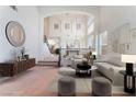 Bright, airy living room with high ceilings, featuring neutral decor, comfortable seating, and an open staircase at 2743 Carolina Blue Ave, Henderson, NV 89052
