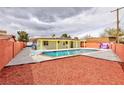 Outdoor pool and lounge area has a diving board and is surrounded by rocks and foliage at 3008 Lawndale St, Las Vegas, NV 89121