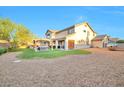 Spacious backyard featuring a covered patio, hot tub, and gravel landscaping at 3784 Cheryl Lynne Ct, Las Vegas, NV 89139