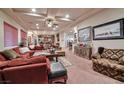 Open living room featuring decorative lighting, plush furniture, and a view to the bar at 3784 Cheryl Lynne Ct, Las Vegas, NV 89139