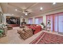 Inviting living room featuring a ceiling fan, fireplace, and plush furniture at 3784 Cheryl Lynne Ct, Las Vegas, NV 89139