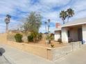 Charming single-story home featuring desert landscaping, palm trees and a brick perimeter wall at 4194 Greenpoint St, Las Vegas, NV 89147