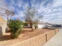 Charming single-story home featuring desert landscaping, palm trees and a brick perimeter wall at 4194 Greenpoint St, Las Vegas, NV 89147