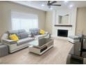 Cozy living room with a white brick fireplace, modern furniture, and plank flooring at 4194 Greenpoint St, Las Vegas, NV 89147