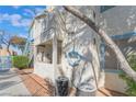 Condo exterior showing second story access, blue trim, and maintained landscape at 4960 Harrison Dr # 131, Las Vegas, NV 89120