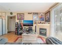 Comfortable living room featuring a fireplace, wood floors, and entertainment center at 4960 Harrison Dr # 131, Las Vegas, NV 89120