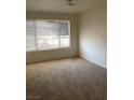 Bright, carpeted bedroom featuring large window with horizontal blinds at 5710 E Tropicana Ave # 2003, Las Vegas, NV 89122