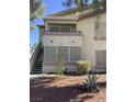 Two-story multi-Gathering building showing stairway, balcony, and desert landscaping at 5710 E Tropicana Ave # 2003, Las Vegas, NV 89122