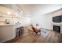 Open-concept living room featuring laminate flooring, fireplace, and lots of natural light at 6704 Dorita Ave # 101, Las Vegas, NV 89108