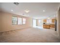 Spacious living room with carpet flooring and plenty of natural light at 7317 Caballo Range Ave, Las Vegas, NV 89179