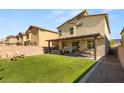 Spacious backyard with a well-maintained lawn, patio area, and privacy fence at 7717 Rosebark Cliffs St, North Las Vegas, NV 89084