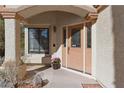 Covered entryway featuring a wooden front door with glass detailing at 8432 Squaw Valley Ave, Las Vegas, NV 89128