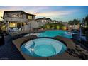 Beautiful backyard oasis with a sparkling pool and relaxing spa surrounded by lush landscaping at 8639 Tortoise Canyon Ct, Las Vegas, NV 89148