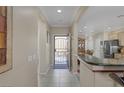 Inviting entryway with security door leading to the open kitchen and dining area at 8645 Deering Bay Dr, Las Vegas, NV 89131