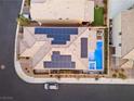 Aerial shot showcases a modern home with solar panels, a pool, and a stylish backyard setup at 8677 Nichols Ave, Las Vegas, NV 89148