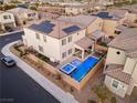 Stunning backyard featuring a sparkling pool, spa, and covered patio, perfect for outdoor relaxation at 8677 Nichols Ave, Las Vegas, NV 89148