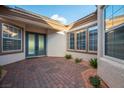 Welcoming front porch featuring decorative brickwork, double doors, and multiple windows for natural light at 10534 Mandarino Ave, Las Vegas, NV 89135
