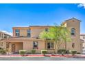 Beautiful multi-story condo featuring manicured shrubs, desert landscaping, and a red tile roof at 1056 Via Panfilo Ave, Henderson, NV 89011