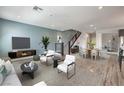 Bright and airy living room featuring modern furniture, stylish decor, and an inviting open floor plan at 1056 Via Panfilo Ave, Henderson, NV 89011