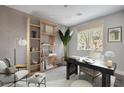 Well-lit office with modern desk, shelving, and large window, creating an ideal workspace environment at 1056 Via Panfilo Ave, Henderson, NV 89011