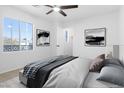 Spacious bedroom featuring bright natural light, neutral paint, and carpet, with views to the outside at 10651 Streamside Ave, Las Vegas, NV 89129