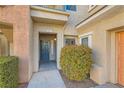 Close up view of the front door of this lovely condo featuring professionally maintained landscaping at 10800 Amber Ridge Dr # 103, Las Vegas, NV 89144