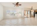 Bright and spacious living room with neutral tile flooring and large windows offering an abundance of light at 10800 Amber Ridge Dr # 103, Las Vegas, NV 89144