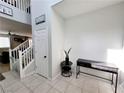 Bright entryway with tiled floors, staircase, and console table at 10819 Far Country Ave, Las Vegas, NV 89129