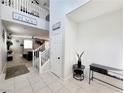 Inviting foyer with tiled floors, high ceilings, and an open staircase leading to the upper level at 10819 Far Country Ave, Las Vegas, NV 89129