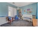 Bright living space featuring stylish furniture, decor, and a large window for natural light at 112 Austin Rose Ave, Henderson, NV 89002