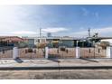 Charming single-story home with a decorative metal fence and low-maintenance landscaping at 1203 Tamerack Ave, Las Vegas, NV 89106