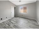 Empty bedroom features hardwood floors, bi-fold door closet, and window at 1578 Ward Frontier Ln, Henderson, NV 89002