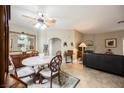 Elegant dining room features a decorative ceiling fan, marble-top table, and access to living area at 2050 W Warm Springs Rd # 4322, Henderson, NV 89014