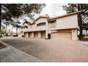 Stunning exterior view of a townhome featuring individual garages and manicured landscaping at 2050 W Warm Springs Rd # 4322, Henderson, NV 89014