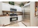 Bright kitchen with stainless steel appliances, white cabinets, and neutral countertops at 2050 W Warm Springs Rd # 4322, Henderson, NV 89014