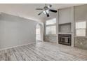 Inviting living room boasting wood-look floors, a fireplace, and built-in shelving at 2471 Grand Basin Dr, Las Vegas, NV 89156