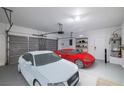 Two-car garage showcasing ample space and storage options with two parked cars at 2648 E Sparrow Way, Pahrump, NV 89048