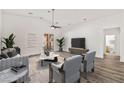 Spacious living room with wood floors, modern decor, and a sliding glass door leading to the outdoor area at 2648 E Sparrow Way, Pahrump, NV 89048