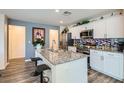 Modern kitchen with granite countertops, stainless steel appliances, and center island with bar seating at 2773 Frosted Teal Ave, North Las Vegas, NV 89086