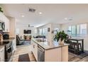 Open-concept kitchen boasts stainless steel appliances and a center island that connects to the living area at 2773 Frosted Teal Ave, North Las Vegas, NV 89086