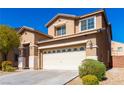 Inviting two-story home featuring a spacious two-car garage and well-maintained landscaping under a clear blue sky at 304 Iron Summit Ave, North Las Vegas, NV 89031